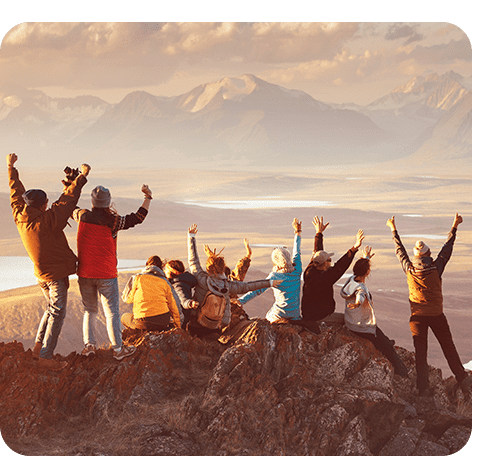 People celebrating on top of a mountain