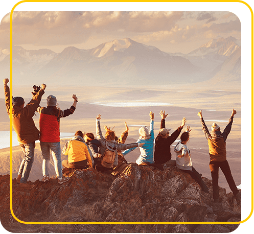 People celebrating on top of a mountain