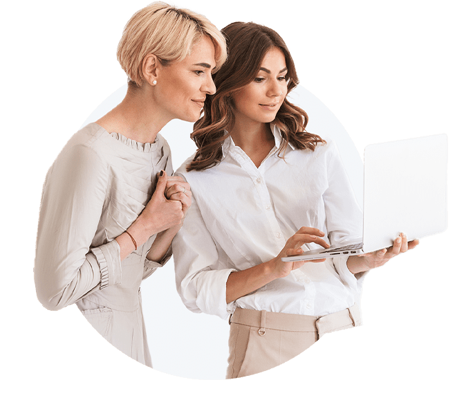 Two women looking at a laptop